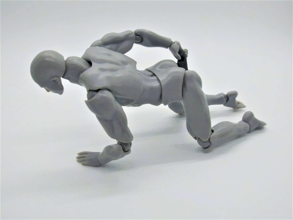 Positions for using a dildo for men: photo of a male figure in the doggy position using an anal dildo.