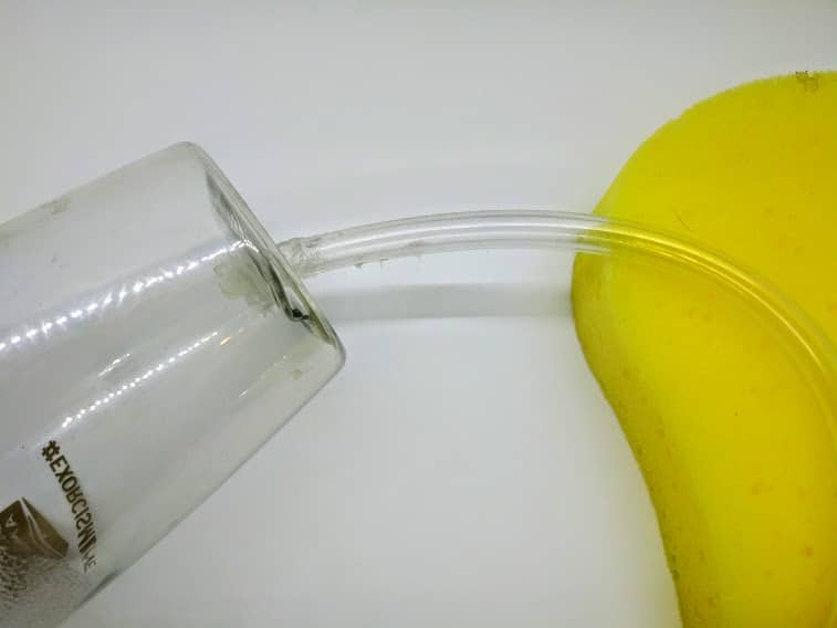 DIY penis pump; photo of step 5 showing the tube being propped up during the drying process.