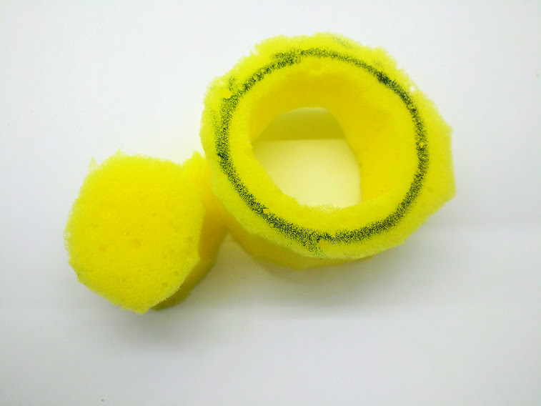 Homemade penis pump; photo of a circular shaped piece of sponge with the center cut out.