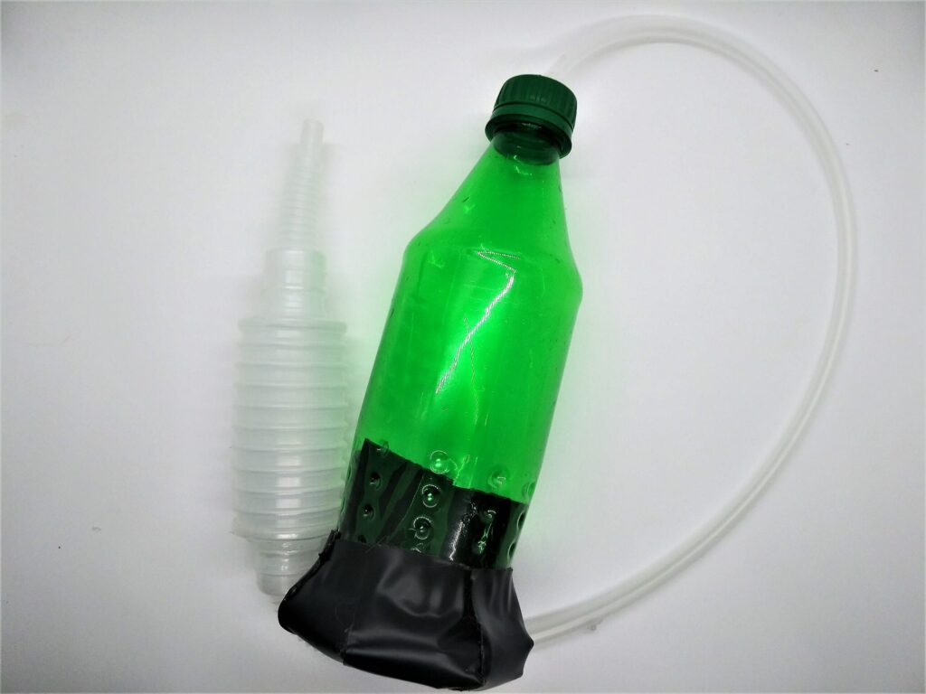 Homemade penis pump guide; photo showing step 10 and the finished penis pump made from a soda bottle.