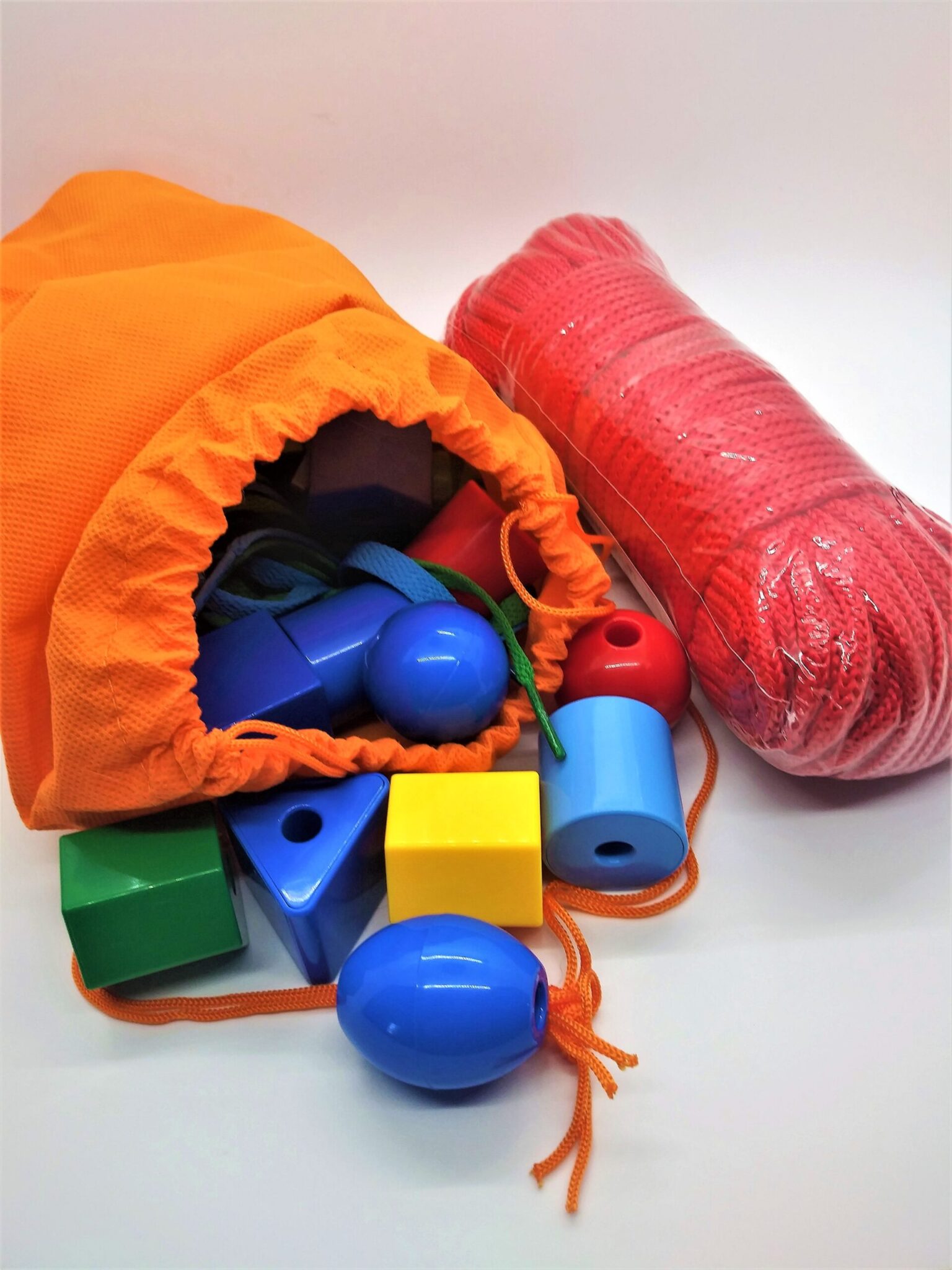 BIY anal beads. Photo of a bag of children's plastic stringing beads and a package of red, nylon rope.
