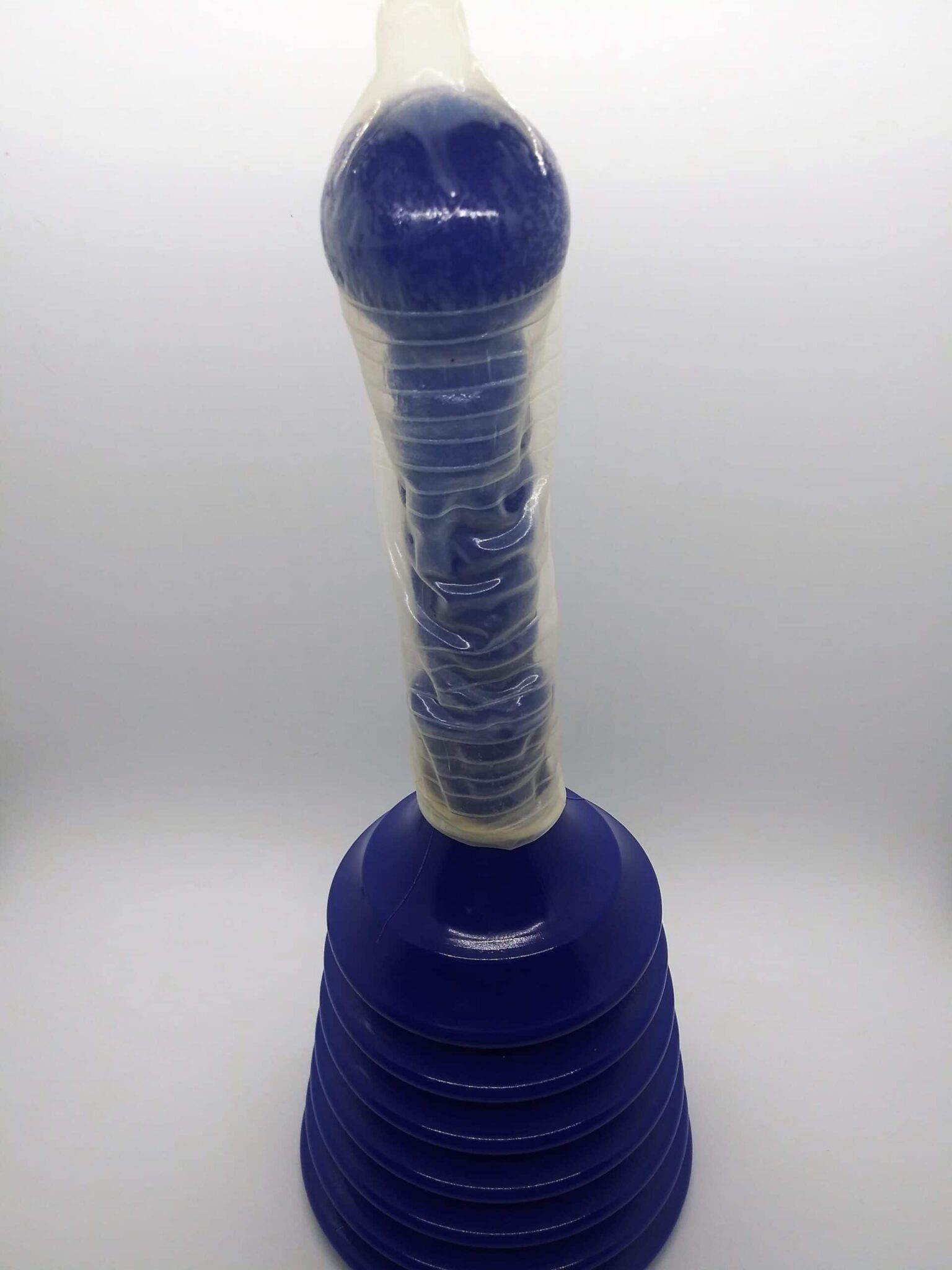 DIY anal sex toys, photo of a blue accordion style sink plunger with a condom covering the handle.