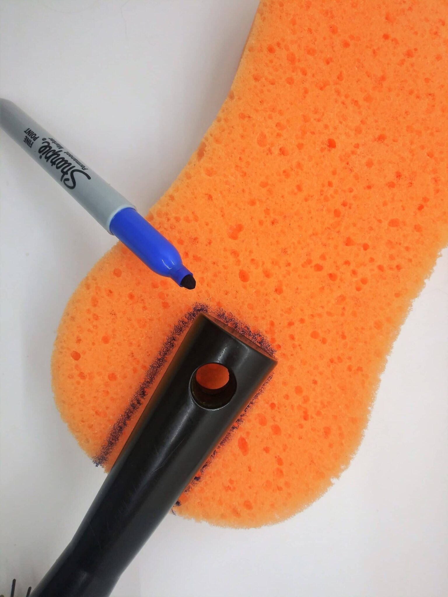 DIY anal sex toys hairbrush, step 2 photo of a hairbrush handle being traced onto a sponge