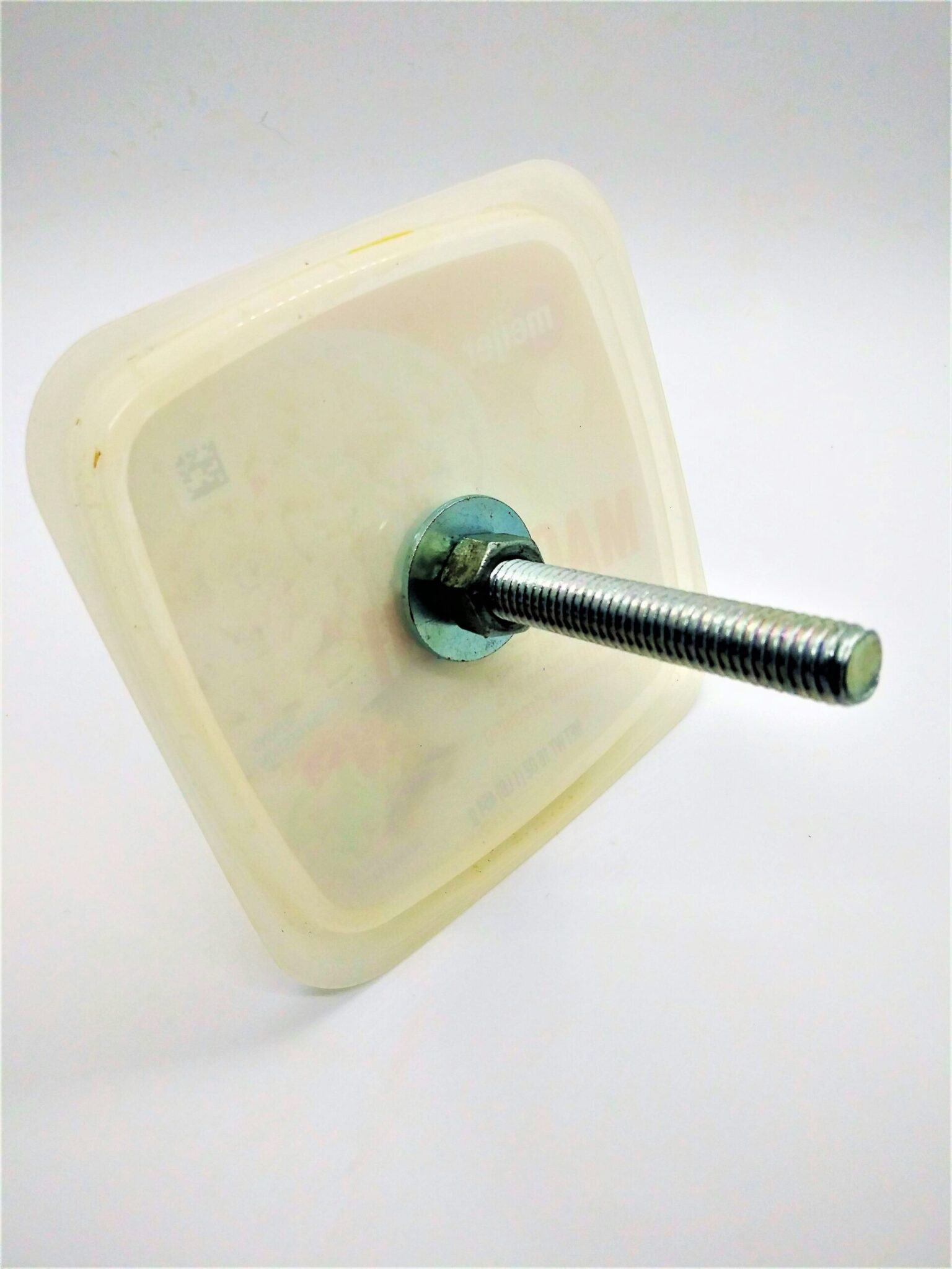 DIY anal sex toys, making a vegetable base. Photo of a plastic lid with a j-bolt through the middle tightened with a washer and nut on both sides of the lid.