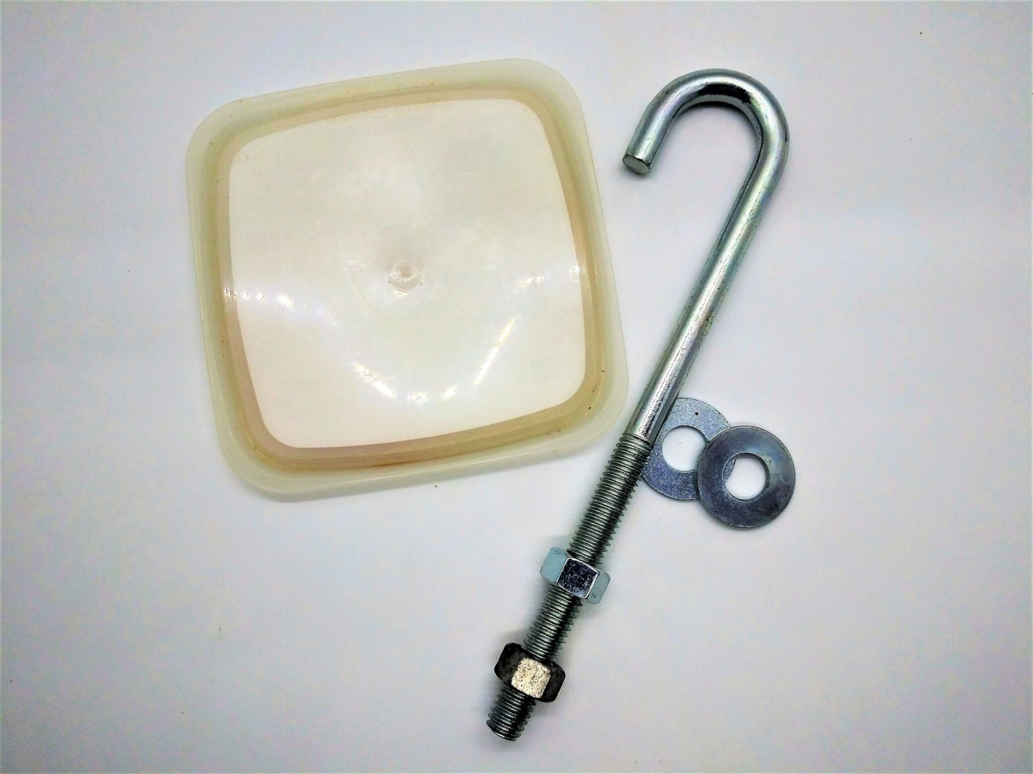 DIY anal sex toy base for longer vegetables. Photo of a plastic lid, 7" long j-bolt, 2 washers and 2 nuts.