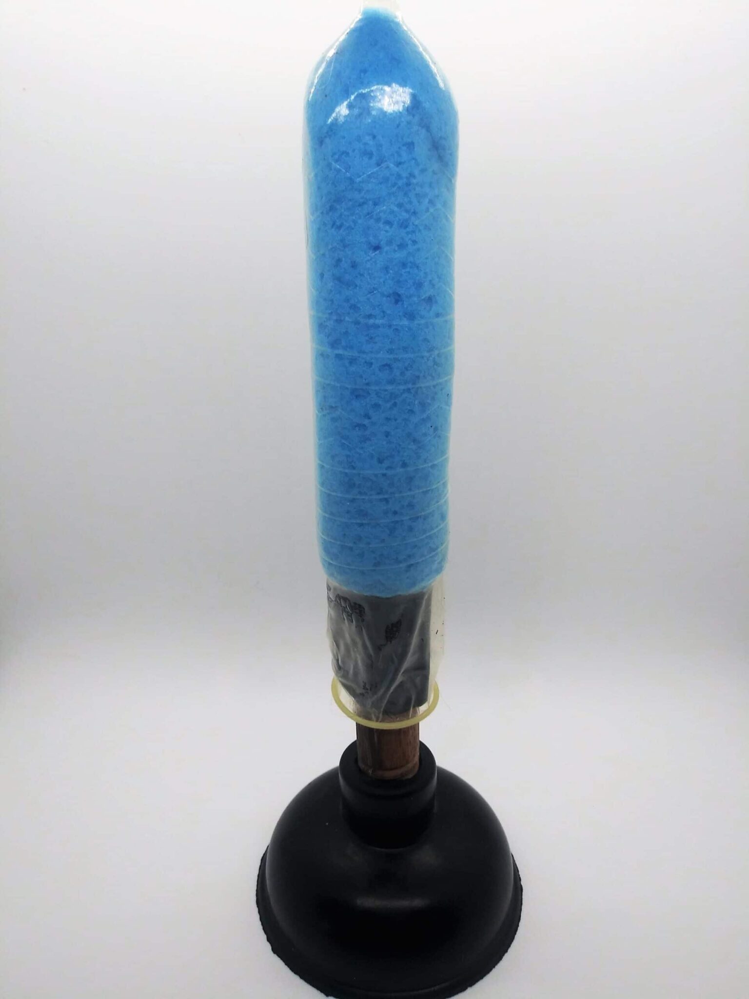 DIY anal sex toys using a plunger. Photo of a small, sink plunger with the handle covered by a sponge and condom.