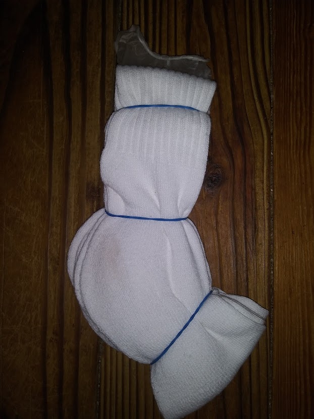 DIY pocket pussy using stacked socks. showing how to place rubber bands on the socks.