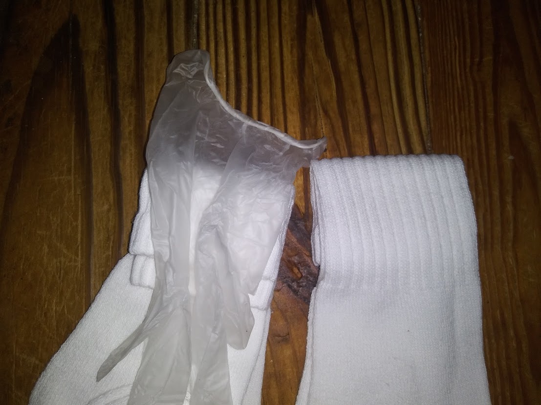 DIY pocket pussy using stacked socks. Showing how to place a medical glove on top of 1 sock.