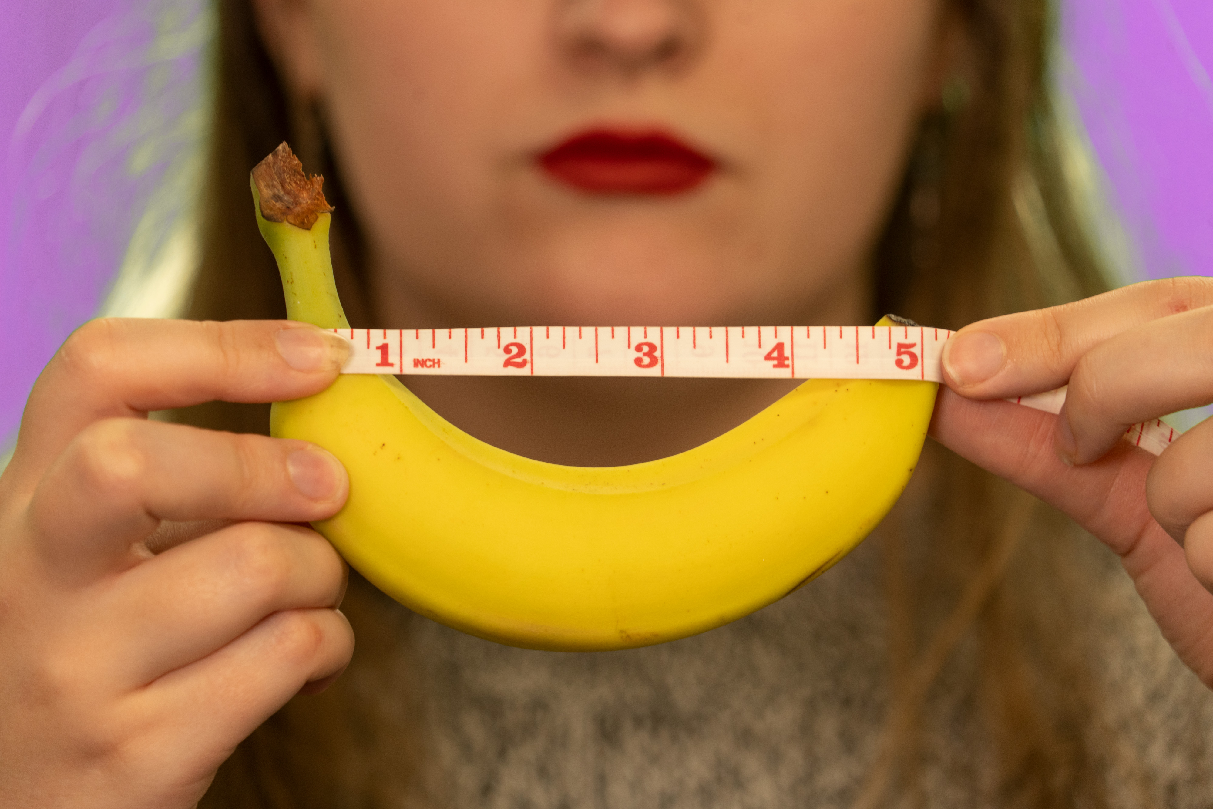 Girl measuring banana