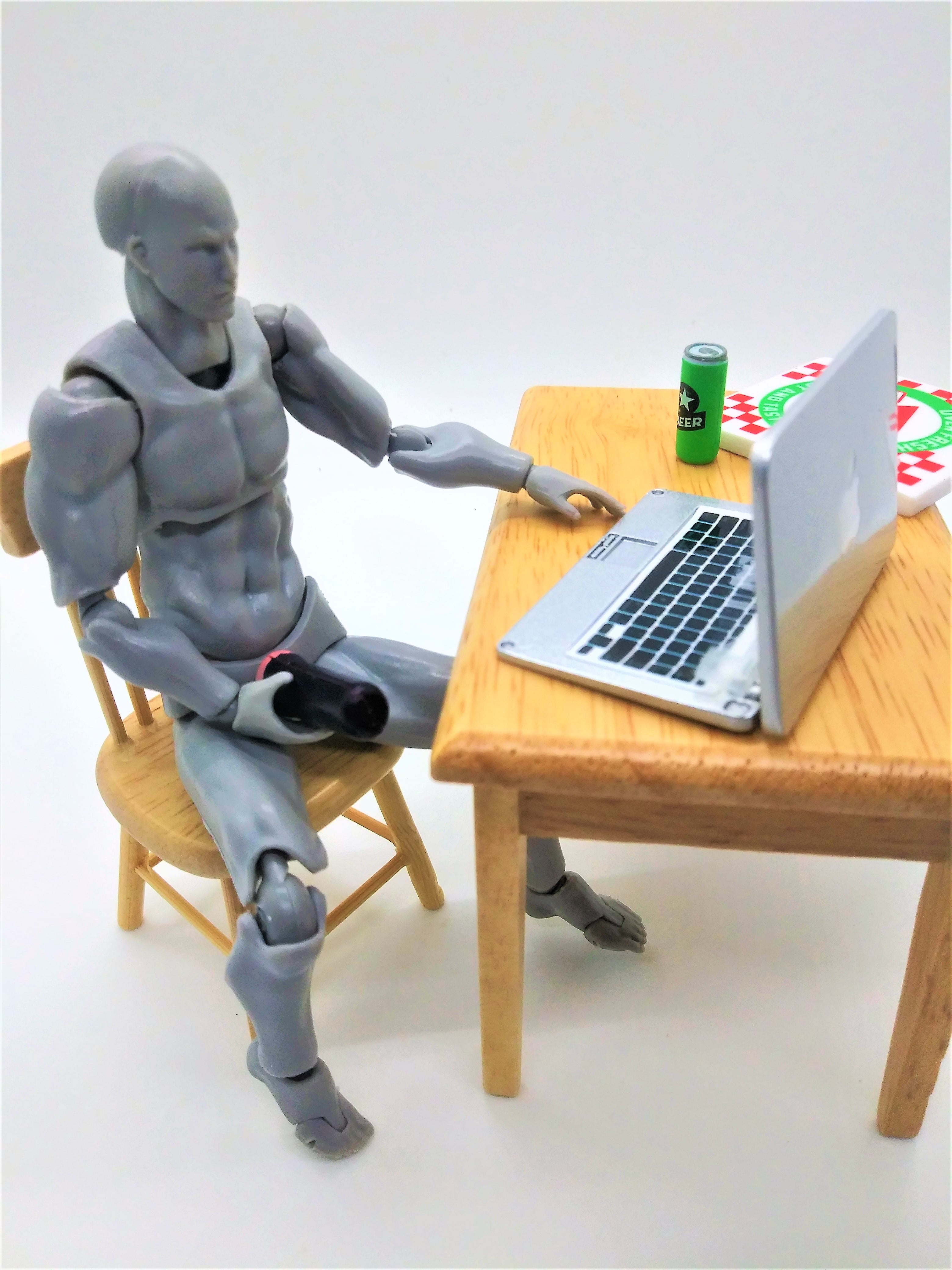 figure with a fleshlight in hand in front of computer