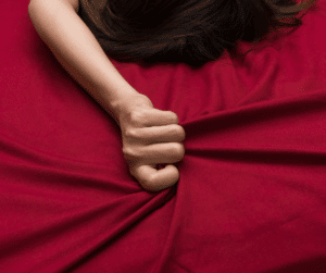 The best ways to give her oral sex, showing a woman gripping sheets