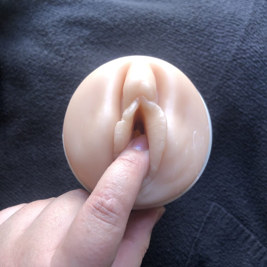 A finger entering the vagina on a fleshlight.