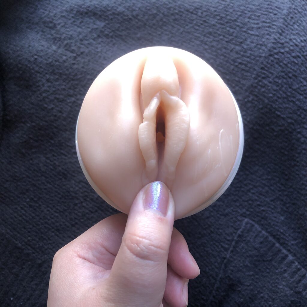 Finger putting pressure on the perineum on a fleshlight.
