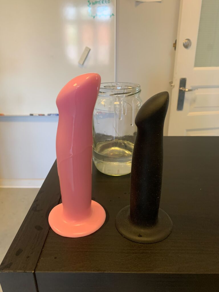 Step 8: The final result after 60 days: Comparing it to the same silicone dildo in a different color, it's easy to see that the pink dildo has swollen and that a chemical reaction is ongoing. In other words: Don't use silicone lube with silicone toys. 